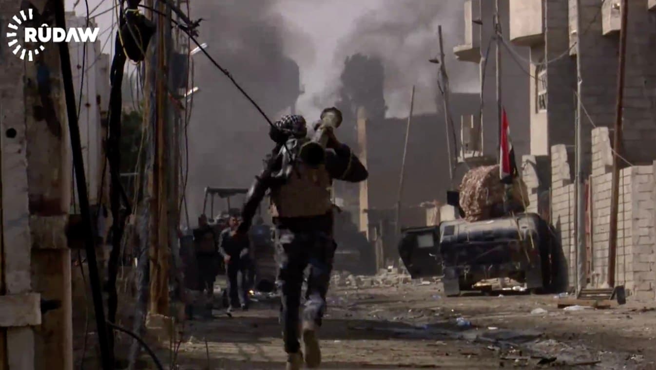 An Iraqi soldier rushes to aid his fellow comrades after an ISIS car bomb exploded nearby in the newly liberated Jawsaq neighborhood in western Mosul. Photo: Rudaw video