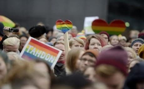 Supporters of same-sex marriage celebrate outside the Finnish parliament the passing of a law allowing same-sex marriages in 2014. AFP