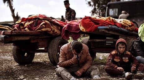 Family members mourn the deaths of loved ones killed in the offensive to retake western Mosul from ISIS. Photo: Aris Messinis | AFP