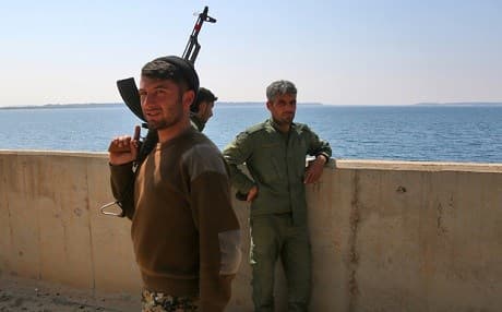 SDF fighters on a section of Tabqa Dam. Photo: AFP