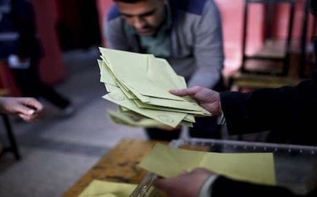 Members of an electoral committee take part in a counting procedure after the closing of the voting inside a polling station in Diyarbakir, southeastern Turkey. Photo: AP