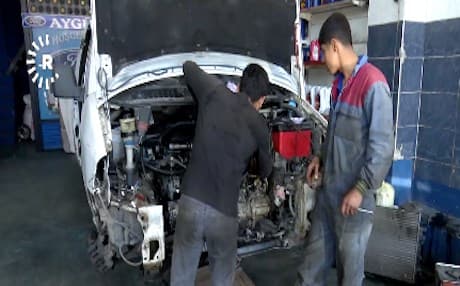 Two Kurdish boys work at a mechanic shop in Turkey. Photo: Rudaw video