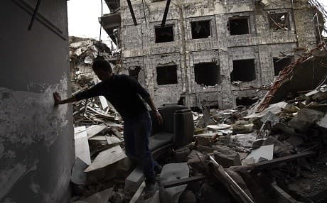 An Iraqi volunteer walks amid the rubble of the destroyed buildings of Mosul's University in east of Mosul as he looks for documents that may have survived earlier this month. Photo: AFP/Christophe Simon