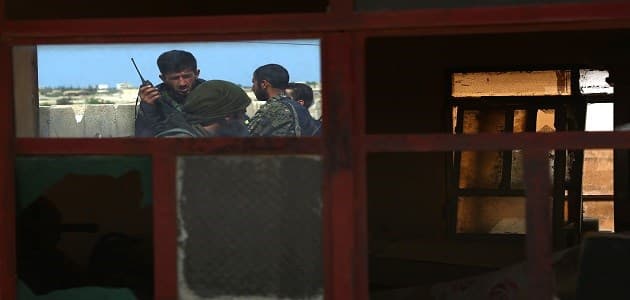 Members of the US-backed multi-ethnic Syrian Democratic Forces (SDF) hold a position in the town of Tabqa, about 55 kilometres west of Raqa city on Sunday as part of their operation to isolate and eventually recapture the ISIS-held Raqqa, the group's de facto capital. Photo: AFP/Delil Souleiman