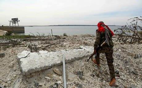 A Syrian Democratic Fighter walks near the Euphrates river near Tabqa, Syria, in April 2017. Photo: AFP