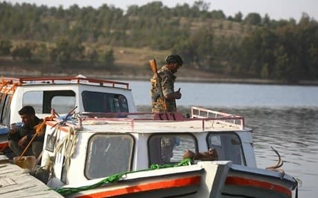 Members of Syrian Democratic Forces stand on a boat at the Lake Assad. Photo: AFP