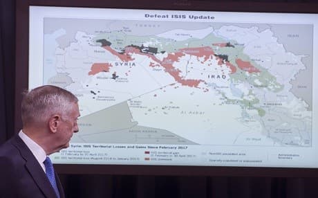 US Secretary of Defense Jim Mattis looks at a map of the Middle East showing ISIS positions as he holds a press briefing at the Pentagon in Washington, DC, on May 19, 2017. The US has so far limited its relations with Syrian Kurds at a military level, though the mainly-Kurdish administration has shown willingness to develop political and diplomatic ties with the United States. Photo: AFP /Saul Loeb