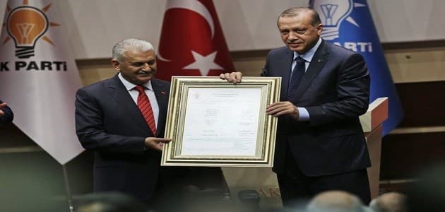 Turkey’s President Recep Tayyip Erdogan, right, poses for photograph with Turkey’s Prime Minister Binali Yildirim, left, during a ceremony to rejoin the ruling Justice and Development Party, or AKP, in Ankaraon on May 2, 2017. . He was the head of the party for 13 years from 2001 until 2014 when he was forced to cut his ties with the party in accordance to the previous constitution. Photo: AP /Burhan Ozbilici. 