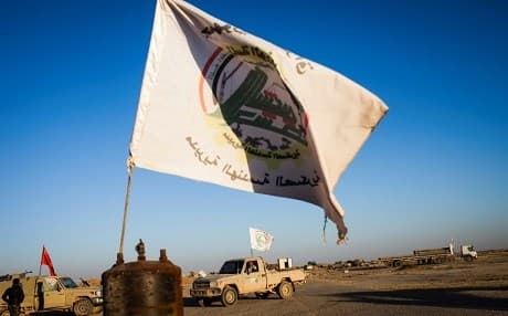 A flag used by the units of Hashd al-Shaabi flies on the tarmac at Tal Afar airport in the province of Nineveh, Iraq. Photo: Achilleas Zavallis | AFP