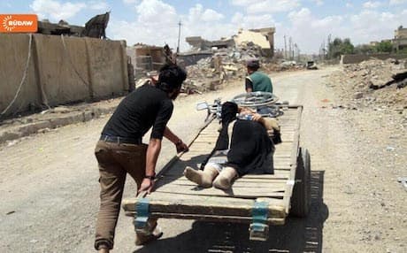 An injured woman is transported by cart through western Mosul. Photo: Rudaw