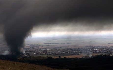 Heavy smoke covers the town of Sinjar during an operation by Iraqi Kurdish forces on November 12, 2015. Photo: Safin Hamed | AFP