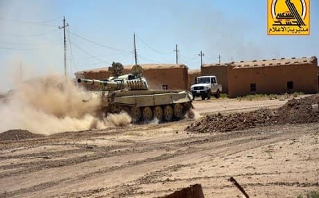 Iraq's Shiite Hashd al-Shaabi forces storm the village of Adnaniyah north of Baaj. Photo: Iraqi PMU