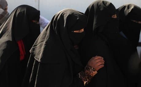 Displaced women wearing a full veil seek shelter south of Mosul this May. Photo: AFP/ Ahmad al-Rubaye