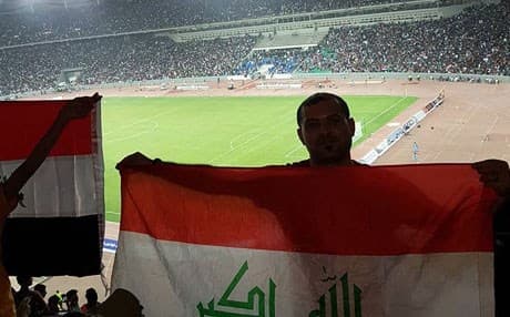 Saif Alisaimmer, an Iraqi football fan, pose for a photo with the Iraqi flag inside the Basra international footbal stadium on May 1, 2017. Photo: Alisammer's facebook account