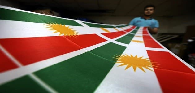 A man prints a flag of Kurdistan in Erbil on June 8, 2017. The Kurdish government will hold a historic referendum on statehood on September 25, despite opposition to independence from the central government of Iraq. Photo: AFP/Safin Hamed