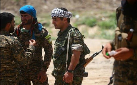 Members of the YPG and Syrian Democratic Forces in a distrcit of Raqqa on June 11. Photo: Delil Souleiman | AFP