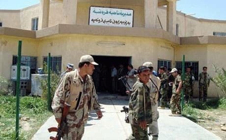Peshmerga guard a municipality building in Qaratapa. File photo: Rudaw