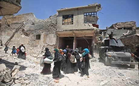 Iraqi women and children carry bags while evacuating from the Old City of Mosul on June 30, 2017, as Iraqi security forces continue their offensive to drive out ISIS from last remaining 600 square meters in Old Mosul. Photo: AFP/Ahmad al-Rubaye