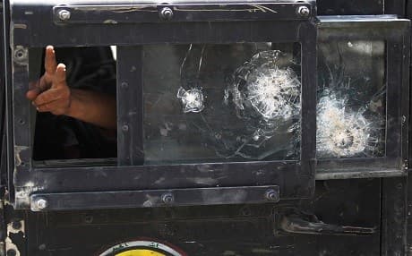   A member of the Iraqi Counter-Terrorism Service (CTS) flashes the victory sign from the window of a humvee during an advance in the old city of Mosul on July 5, 2017. Photo: AFP / Ahmad al-Rubaye