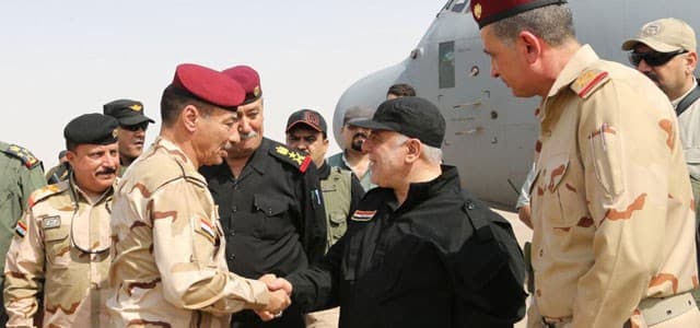 Iraqi Prime Minister Haider al-Abadi, also the commander-in-chief of all armed forces, is being received by the Iraqi commanders in Mosul on July 9, 2017. Photo: PM media office