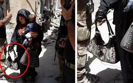This image from Al-Mawsleya TV captures a woman clutching a child and handbags just prior to detonating explosives.