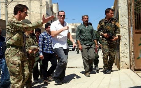 US Envoy to the Global Coalition Brett McGurk [C], and Rupert Jones [L], depurt commander of the coalition's Combined Task Force, arrive for a meeting with officials in the Syrian town of Tabqa in Syria on JUne 29, 2017. Photo: AFP, Delil Souleiman. 