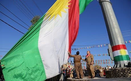 People raise the flag of the Kurdistan Region near the citadel in Erbil's city centre. Photo: Farzin Hassan | Rudaw