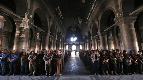 Cardinal Philippe Barbarin, who was split between "sadness" and "hope", holds a mass for the "renaissance" in Qaraqosh. Photos: Safin Hamed | AFP