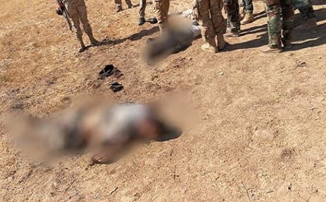 The obscured bodies of two would-be suicide bombers who were killed by Kurdish Peshmerga on the West Tigris front on August 22. Photo: Duhok Command