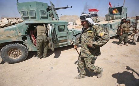 A fighter from the Hashed Al-Shaabi (Popular Mobilization units) walks inside al-Nour neighbourhood in eastern Tal Afar, Iraq, on August 23. Photo: Ahmad al-Rubaye | AFP