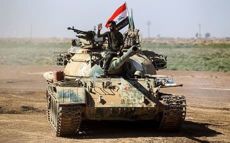  A tank that belongs to the Iranian-backed mainly Shiite Hashd al-Shaabi paramilitaries advance towards villages between the now-liberated Hawija and Kirkuk on October 6, 2017. The paramilitaries have  rejected the Kurdish vote on independence held on September 25. Photo: AFP / Ahmad al-Rubaye