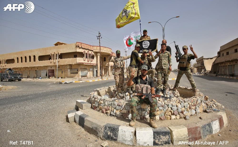 Iraqi forces pose in Hawija town, retaken from ISIS on October 5. Photo: Ahmad al-Rubaye/AFP