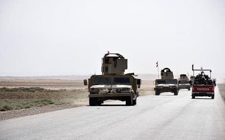 Iraqi army reinforcements drive down a road, linking Hawija to Kirkuk, near the village of Khabbaz on October 7, 2017. Photo: AFP /Marwan Ibrahim
