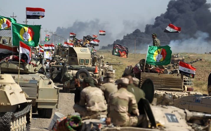 Hashd al-Shaabi fighters advance on Hawija during operations to oust ISIS from the town on October 4. Photo: Ahmad al-Rubaye/AFP