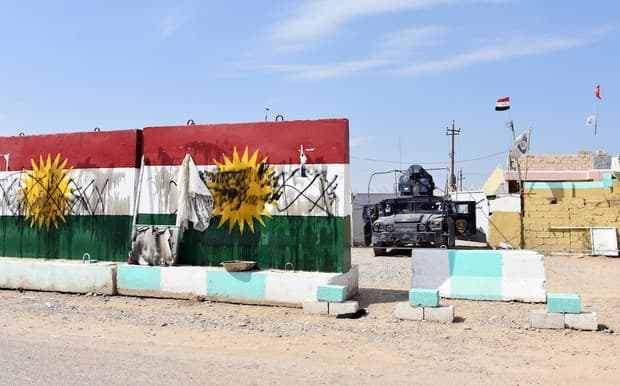Defaced Kurdistan flags at a former Peshmerga position in Tuz Khurmatu now held by Iraqi forces on Friday. Photo: AFP