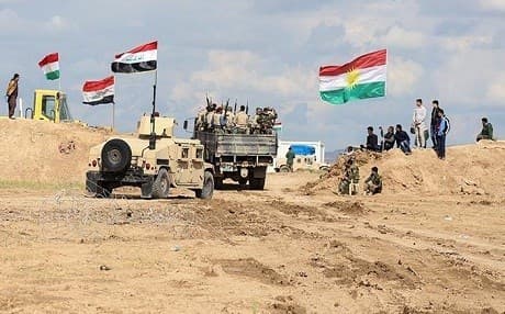 Iraqi Army vehicles pass through Kurdish Peshmerga forces on their way to the Makhmour front in 2016. File photo: Farzin Hassan/Rudaw.