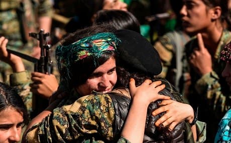 Female fighters of the Syrian Democratic Forces (SDF) gather during a celebration at the iconic Al-Naim square in Raqa on October 19, 2017, after retaking the city from Islamic State (IS) group fighters. Photo:AFP / Bulent Kilic