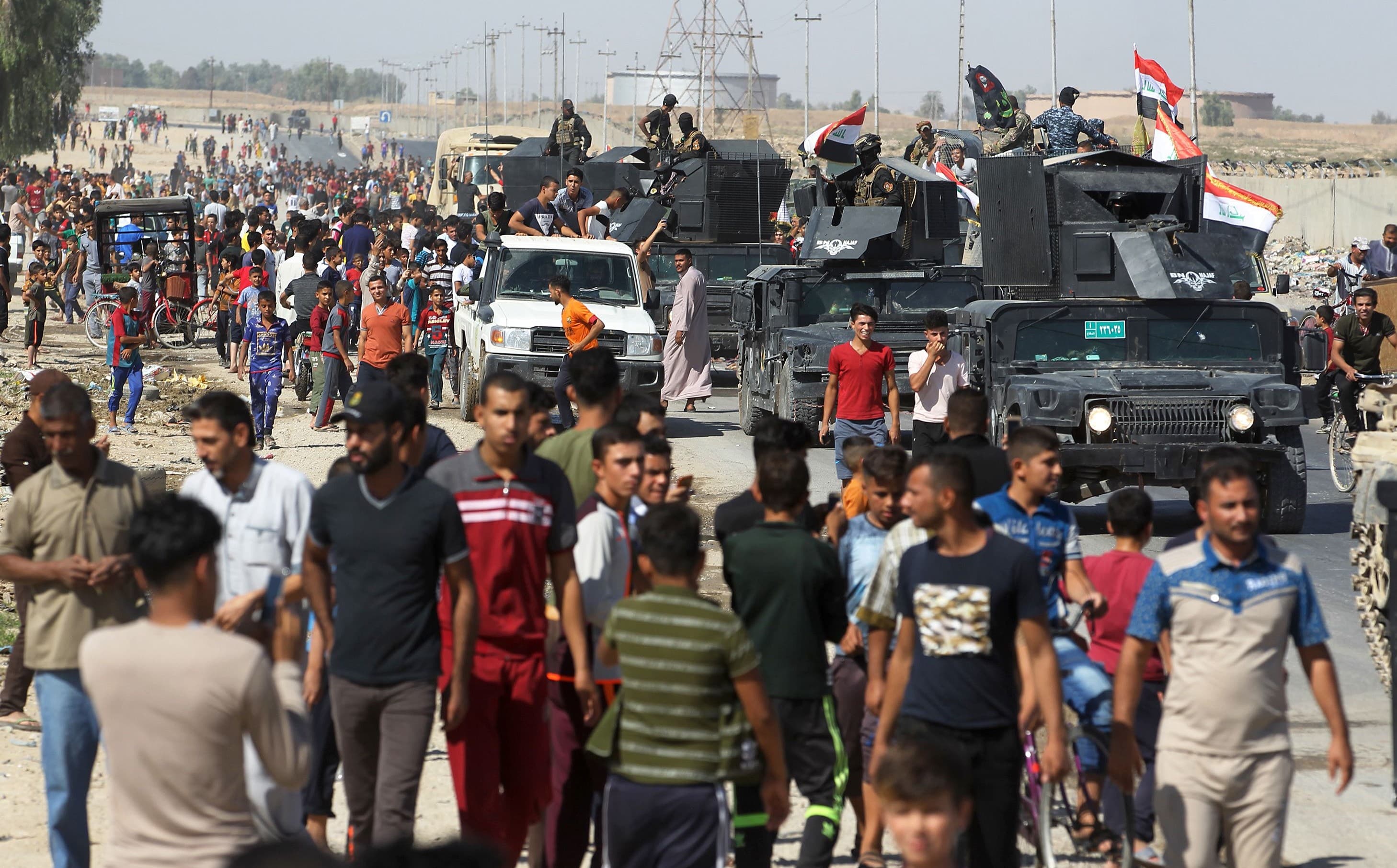 Civilians gather as Iraqi forces arrived in Kirkuk on Monday. Photo: Ahmad al-Rubaye/AFP