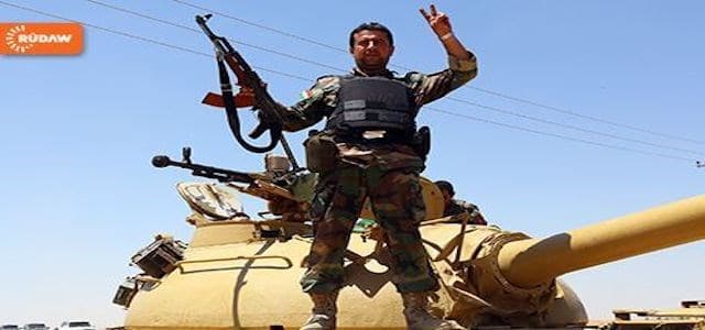 File photo of a Peshmerga soldier flashing victory sign on a tank in Rabia. 