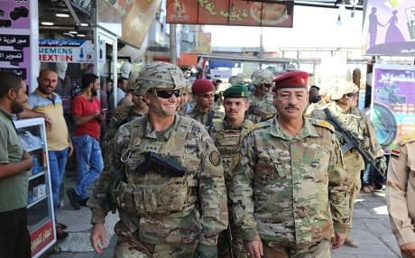 In this Oct. 4, 2017 photo released by the U.S. Army, Lt. Gen. Paul Funk, left, commanding general of Combined Joint Task Force-Operation Inherent Resolve, and Iraqi Maj. Gen. Najm Abdullah al-Jibouri, right, commander of the Nineveh Liberation Operation, walk through a busy market near the University of Mosul. Photo:  (Spc. Avery Howard, U.S. Army via AP)
