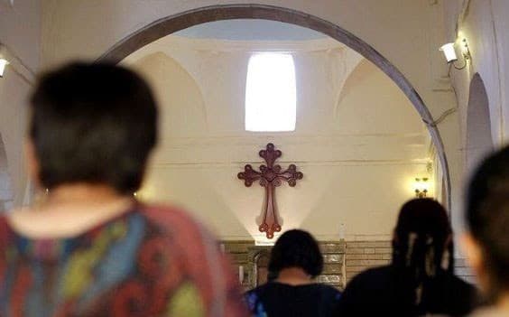 Iraqi Christians pray in a church. File photo: AFP