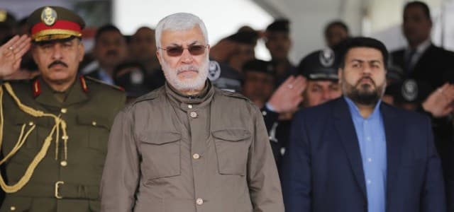 Abu Mahdi al-Muhandis, center, attends a ceremony marking Police Day in Baghdad, Iraq on January 9, 2016. Oct. 30, 2017. (AP Photo/Karim Kadim, File)