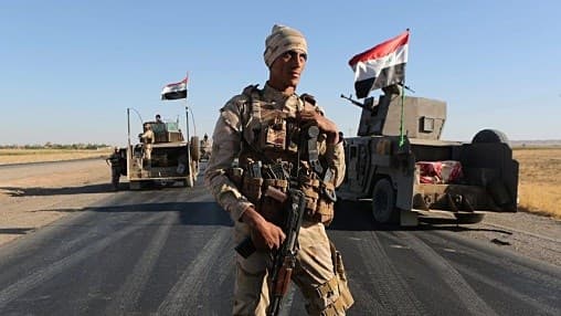 Iraqi security forces gather outside the Kurdish-held city of Altun Kupri on the outskirts of Irbil, Iraq, October 19, 2017. Khalid Mohammed/AP 