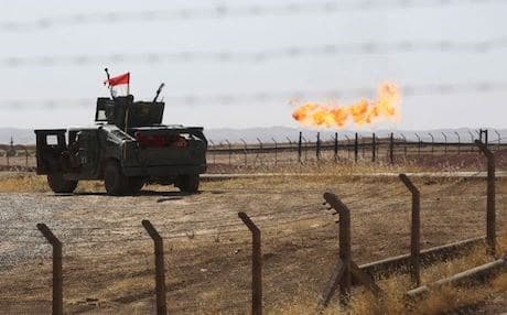 An Iraqi army vehicle stands guard at the Bai Hassan oil field, west of Kirkuk, on October 17, 2017, a day after Iran-backed Hashd al-Shaabi militias and the army took control of Kirkuk after Kurdish Peshmerga pulled their forces out of the city. Photo: AFP/Ahmad al-Rubaye