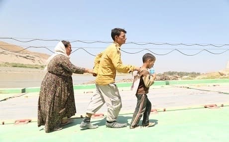 A Yezidi family fleeing the ISIS onslaught against the religious minority make their way back into the Kurdistan Region on a border crossing with the Syrian Kurdistan in August 2014. Many Yezidis who fled the genocide initially sought refuge in Syria before heading to the Kurdish cities in Kurdistan Region and elsewhere. File photo: Rudaw
