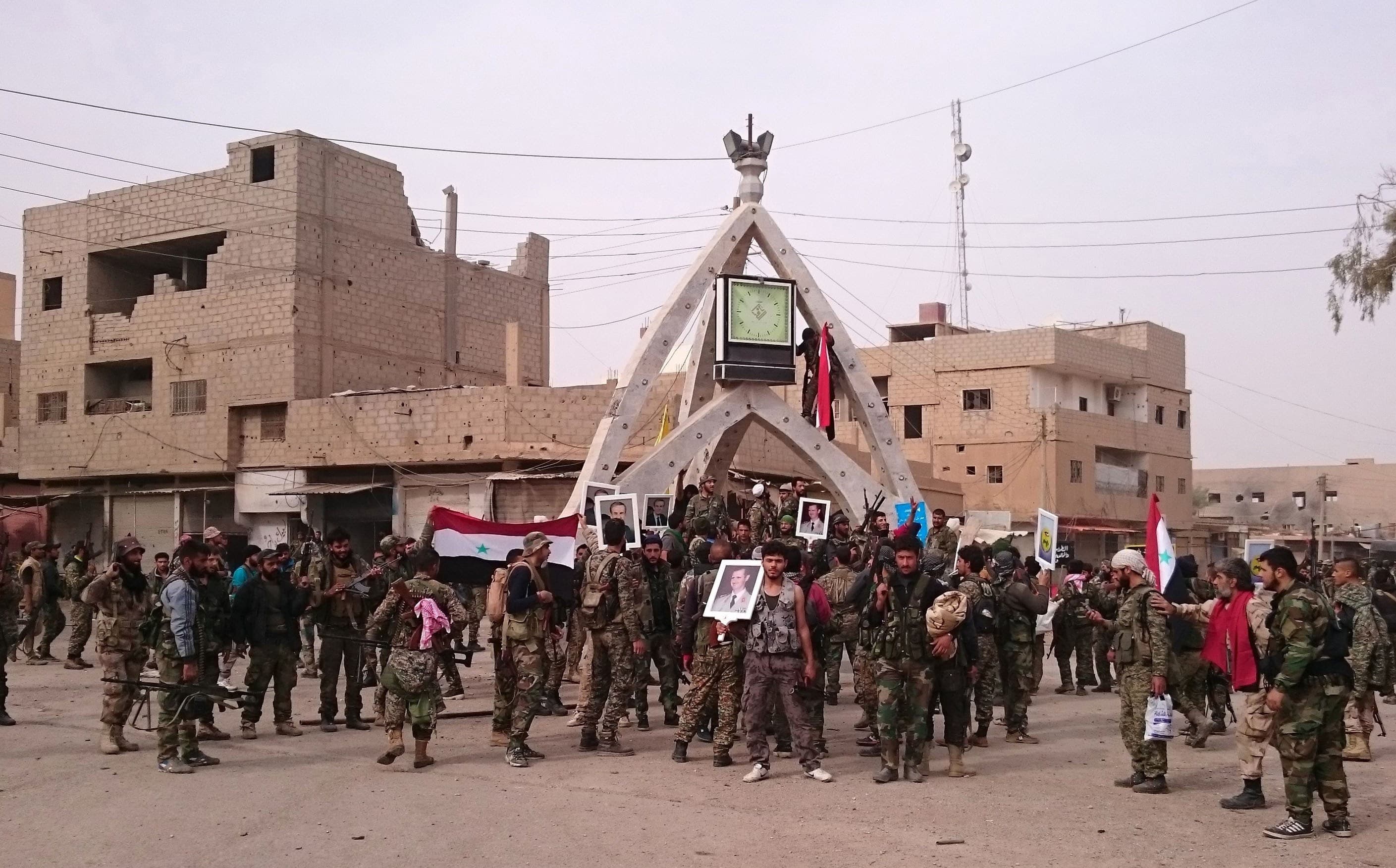 Pro-Syrian government forces gather in al-Boukamal, eastern Syria, on Monday after ousting ISIS from the town. Photo: AFP