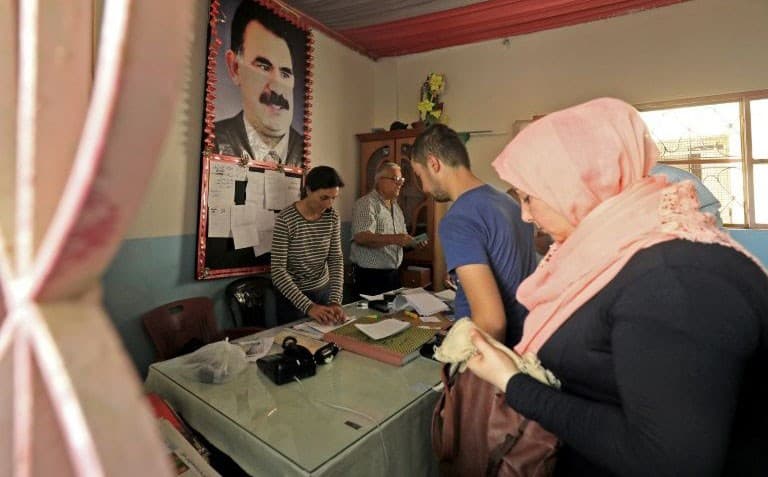 People register to vote during the first round of elections, communal, in Rojava in September. Photo: Delil Souleiman/AFP