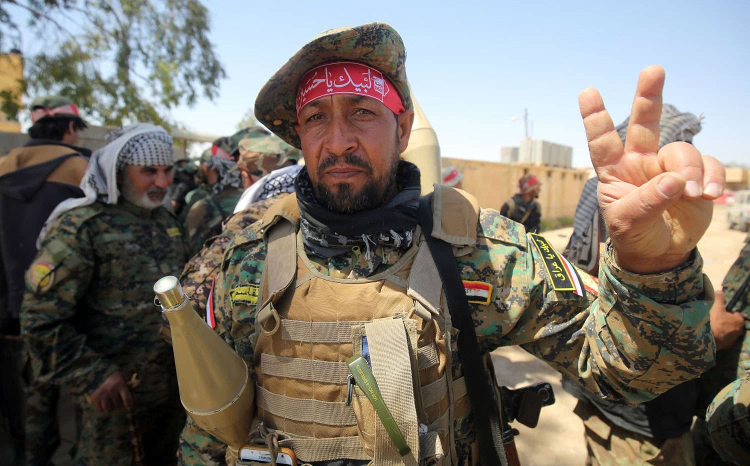A member of the Hashd al-Shaabi flashes a ‘V’ sign in Hatra, Iraq in April. Photo: Ahmad al-Rubaye/AFP