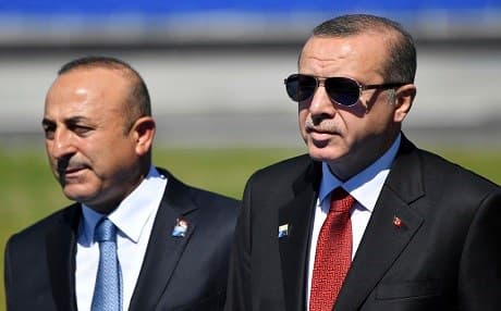 Turkish President Recep Tayyip Erdogan (right) and Foreign Minister Mevlut Cavusoglu arrive at a NATO summit in Brussels in May. Photo: AP