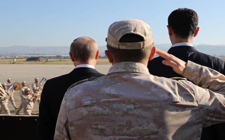 Russian President Vladimir Putin (left) and President of Syria Bashar al-Assad inspect a military parade in Latakia on December 11. Photo: Mikhail Klimentyev | AFP